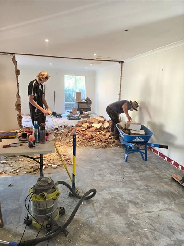 MWJ builders clearing brick during wall removal